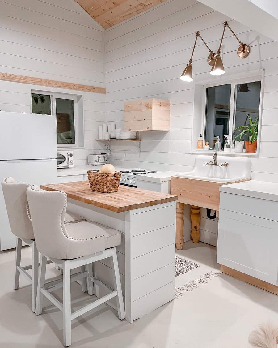 White kitchen with butcher block island and vaulted ceiling