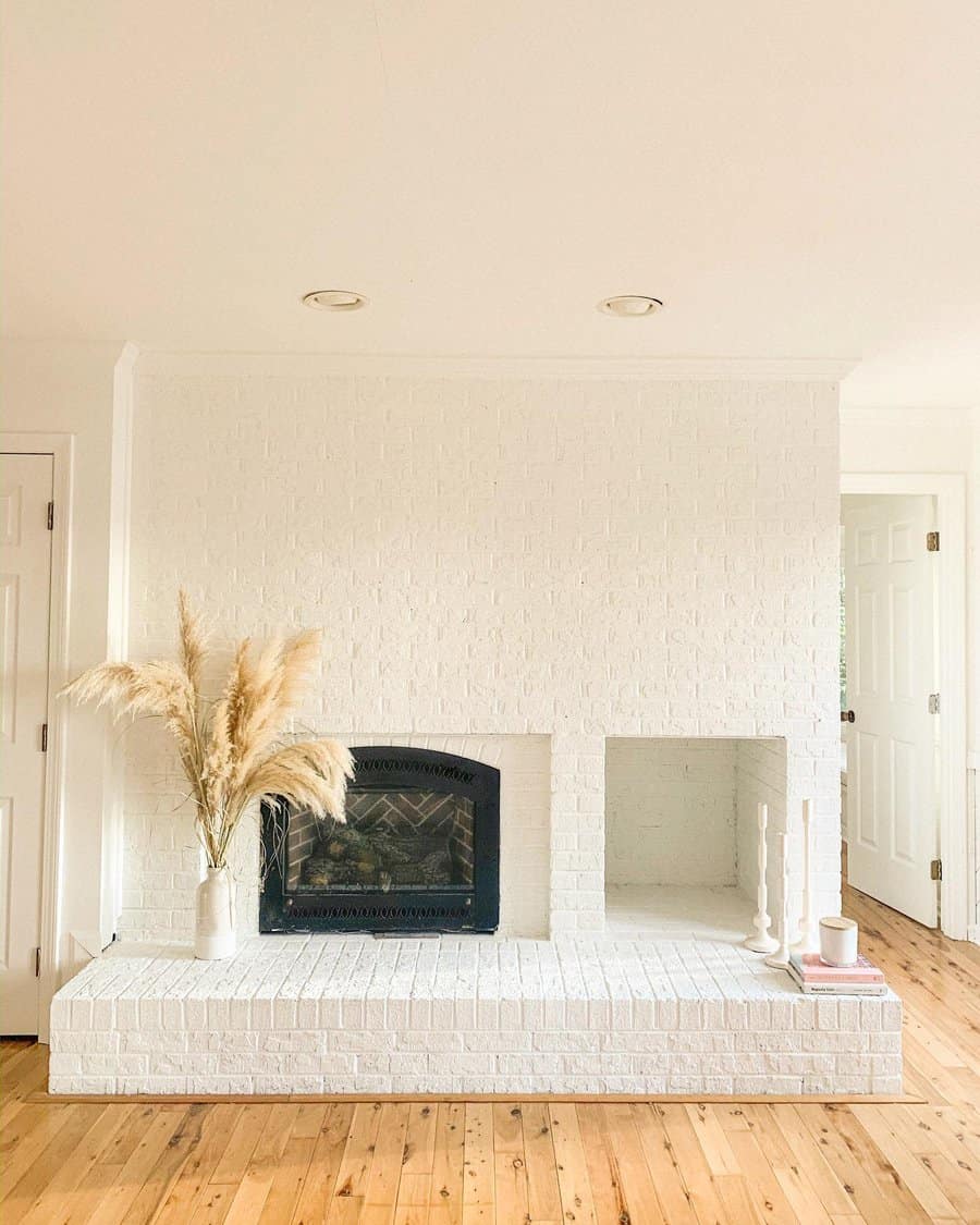 White living room with fireplace and brick wall