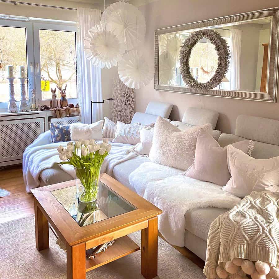 White living room with light pink cushions