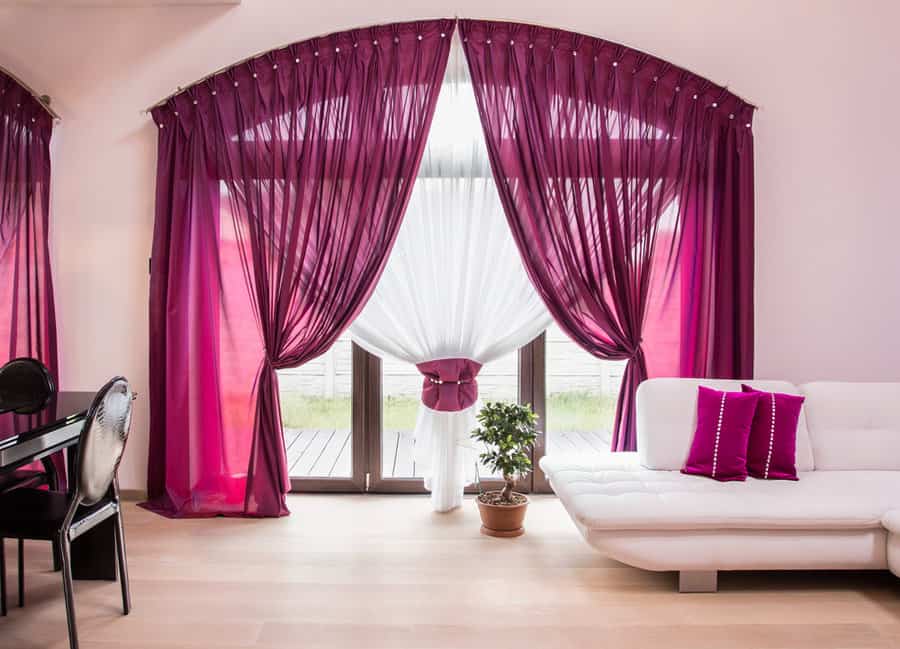 Chic room with white sofa and purple drapes