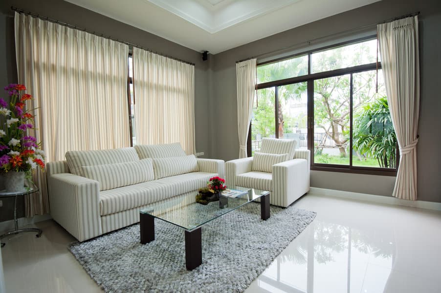 Living room with plush sofa and garden view