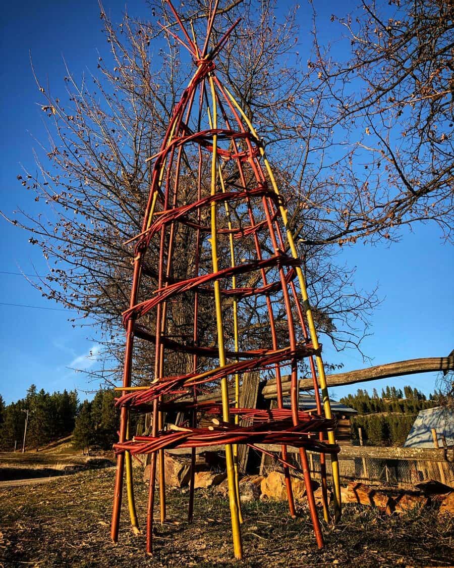 Artistic wooden teepee trellis in a rural setting