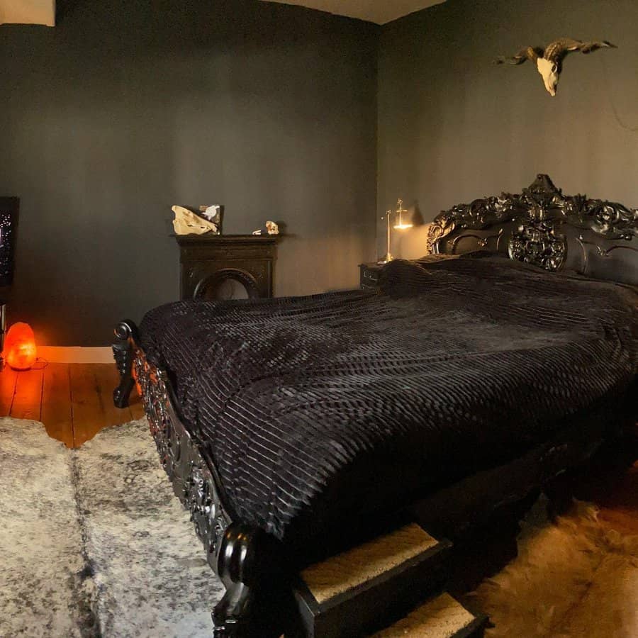 Gothic bedroom with ornate black bed and dark walls