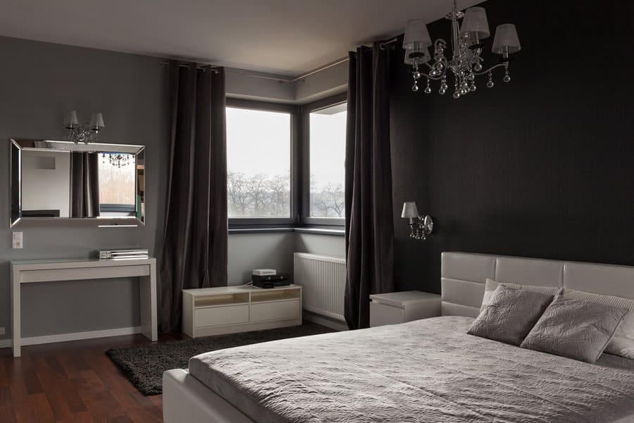 Chic bedroom with dark walls and grey curtains