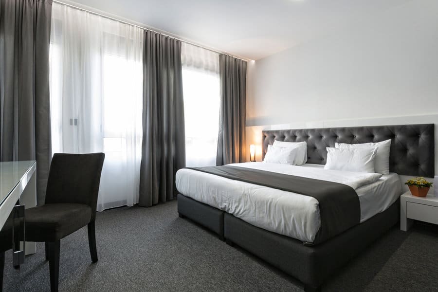 Sleek modern bedroom with gray curtains and bedding