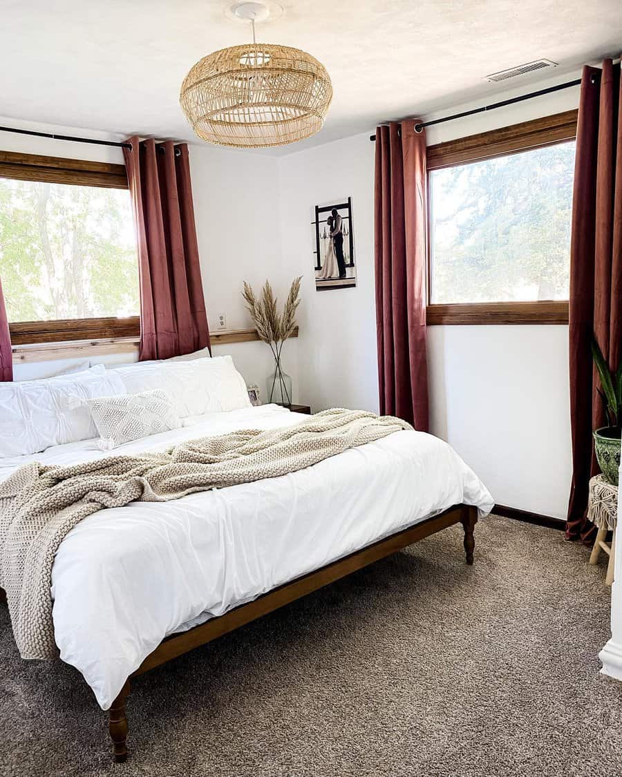 Boho bedroom with rustic red curtains and wicker light