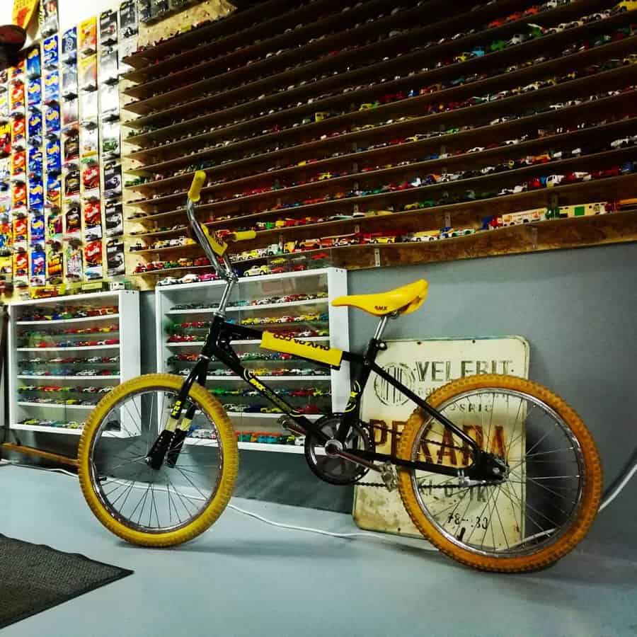 Bike displayed in the garage with the wall mounted car collection