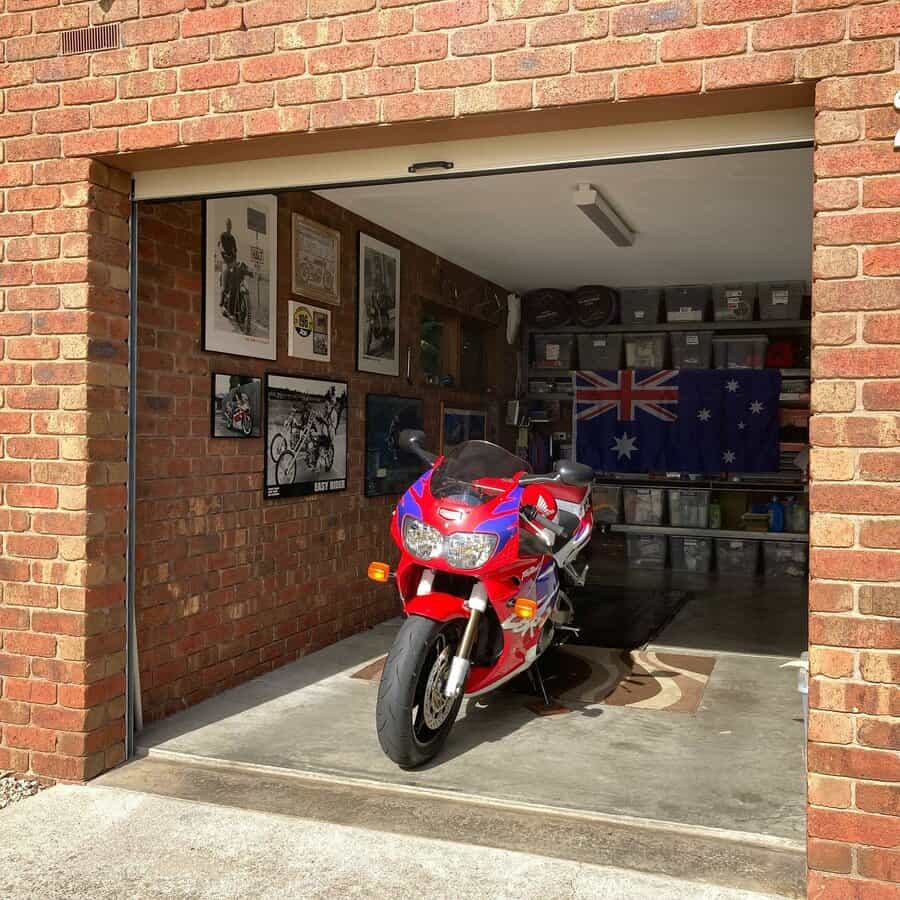 Motorbike parked in the garage with framed pictures and flags