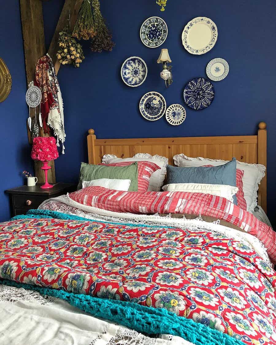 Bedroom with blue walls and a bed with a vibrant quilt