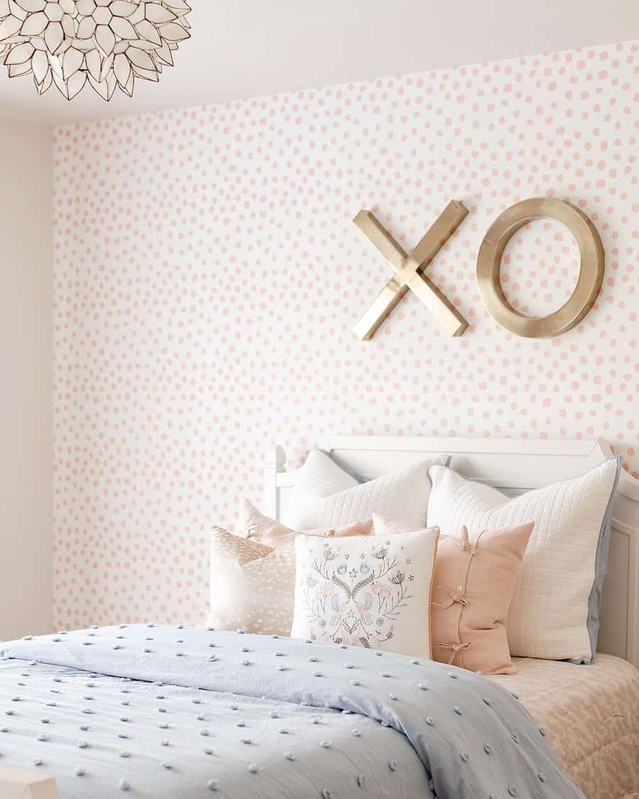 Playful bedroom with pink polka dots wallpaper