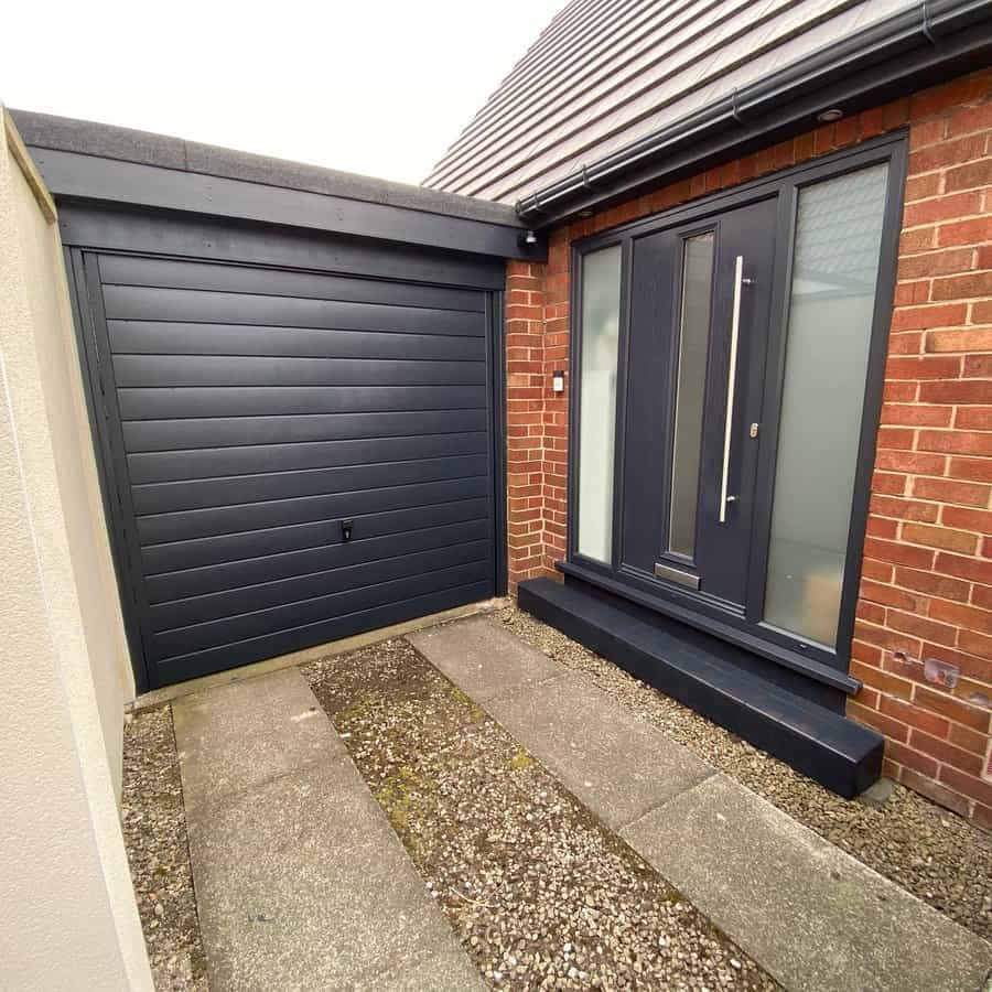 Contemporary home exterior with dark garage door and matching front door