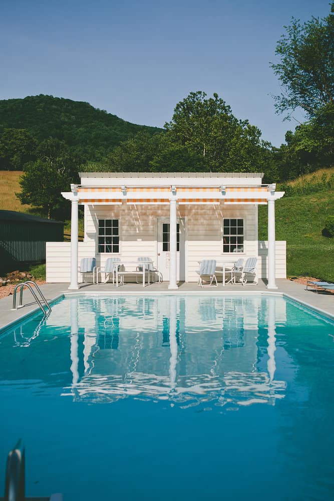 Classic pool house with striped awning