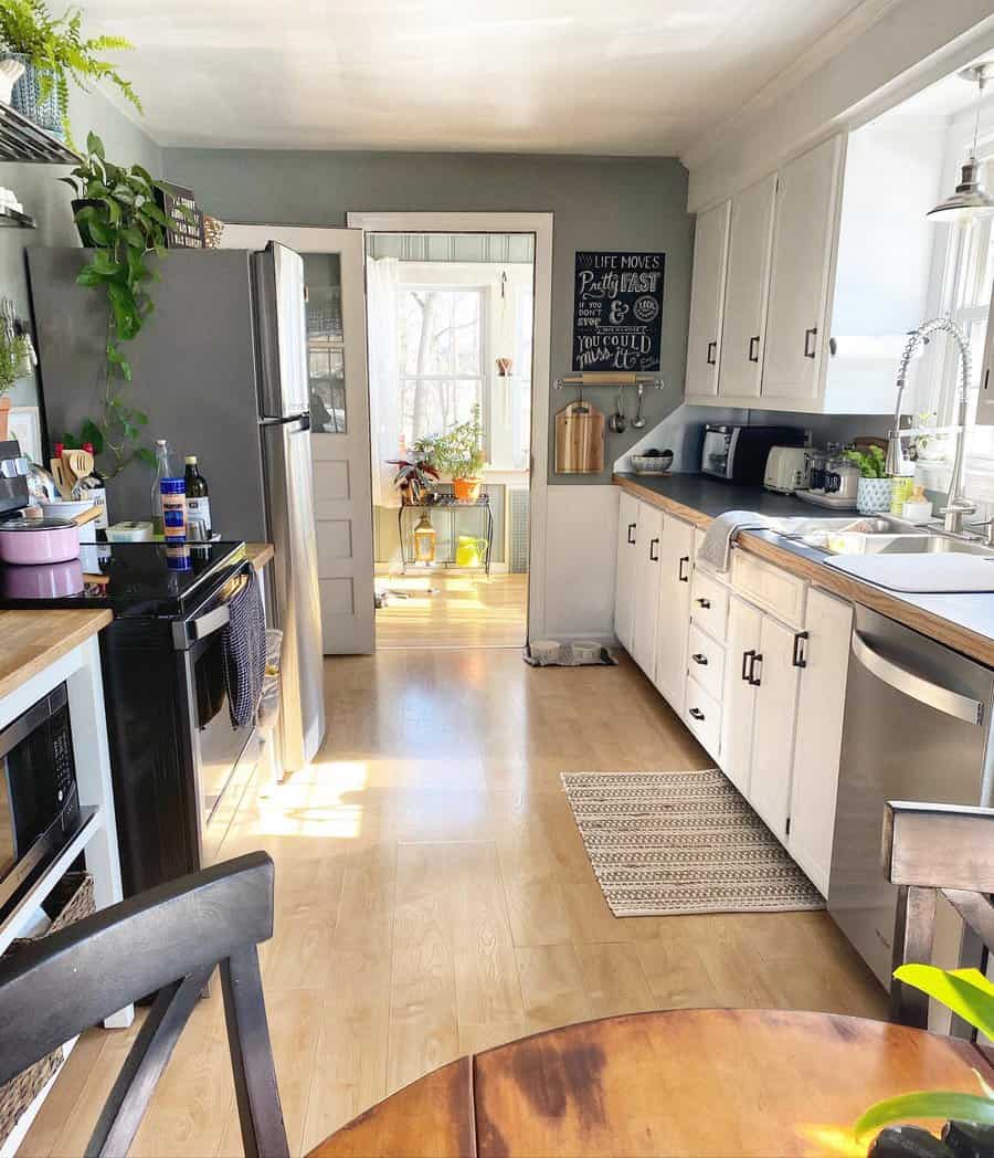 Bright kitchen with white cabinets and wood floors