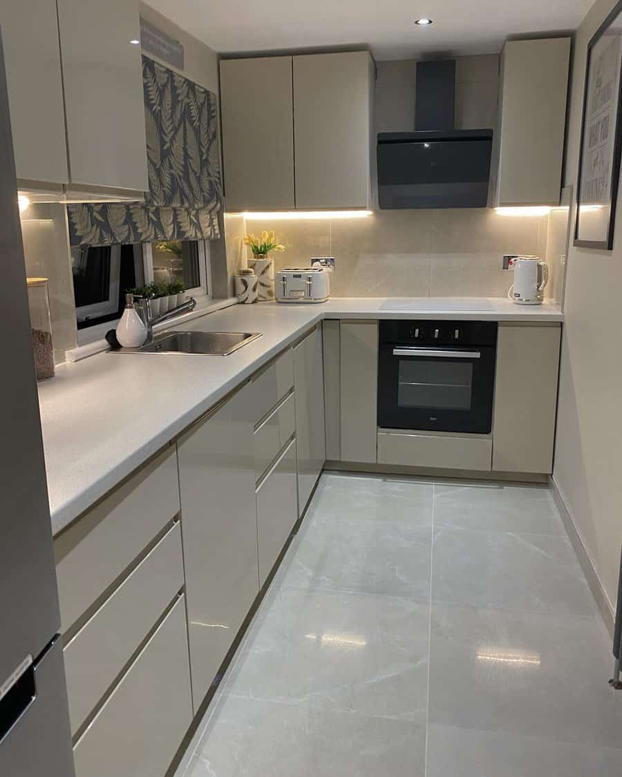 Chic small kitchen with taupe cabinets and LED under lighting