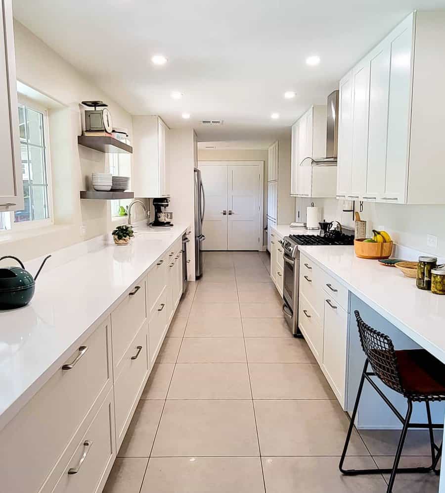 Minimalist white galley kitchen with ample lighting