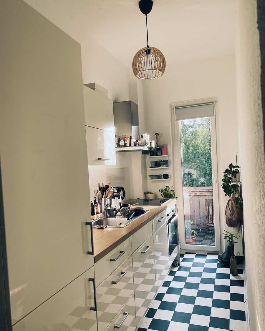 Slim kitchen with checkered floor and pendant light