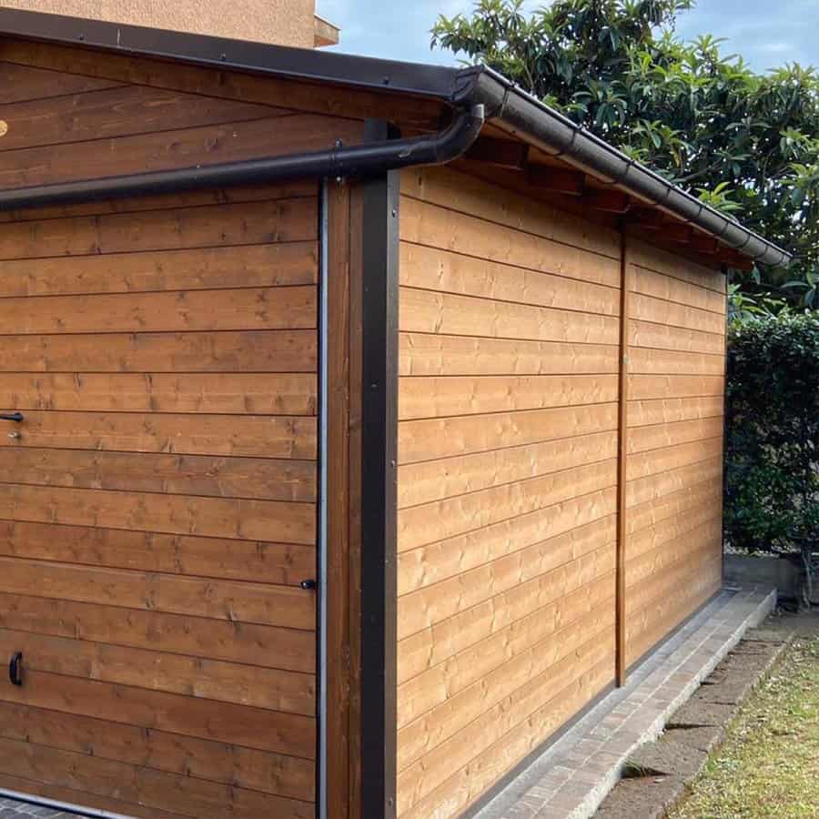 Wooden garage exterior with black trim and gutter