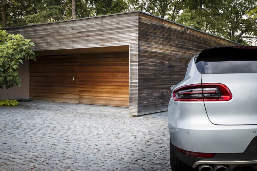 Modern car in front of a sleek wooden garage design