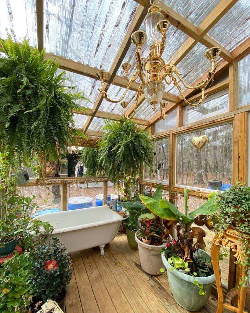 Greenhouse with clawfoot tub and chandelier