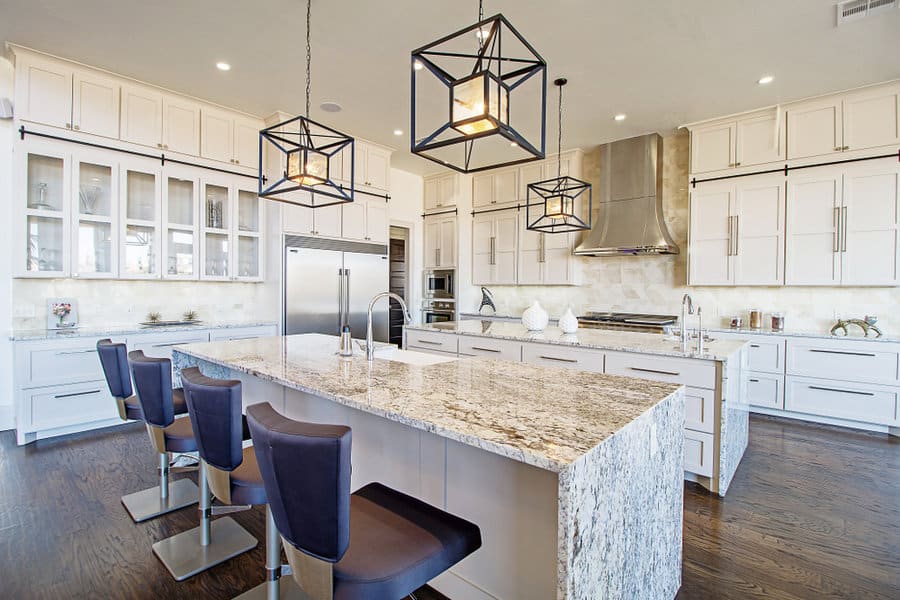 Spacious kitchen with star pendants and marble island