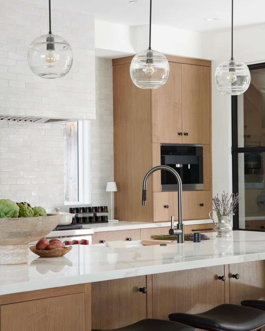 Modern kitchen with glass pendant lighting and wooden accents