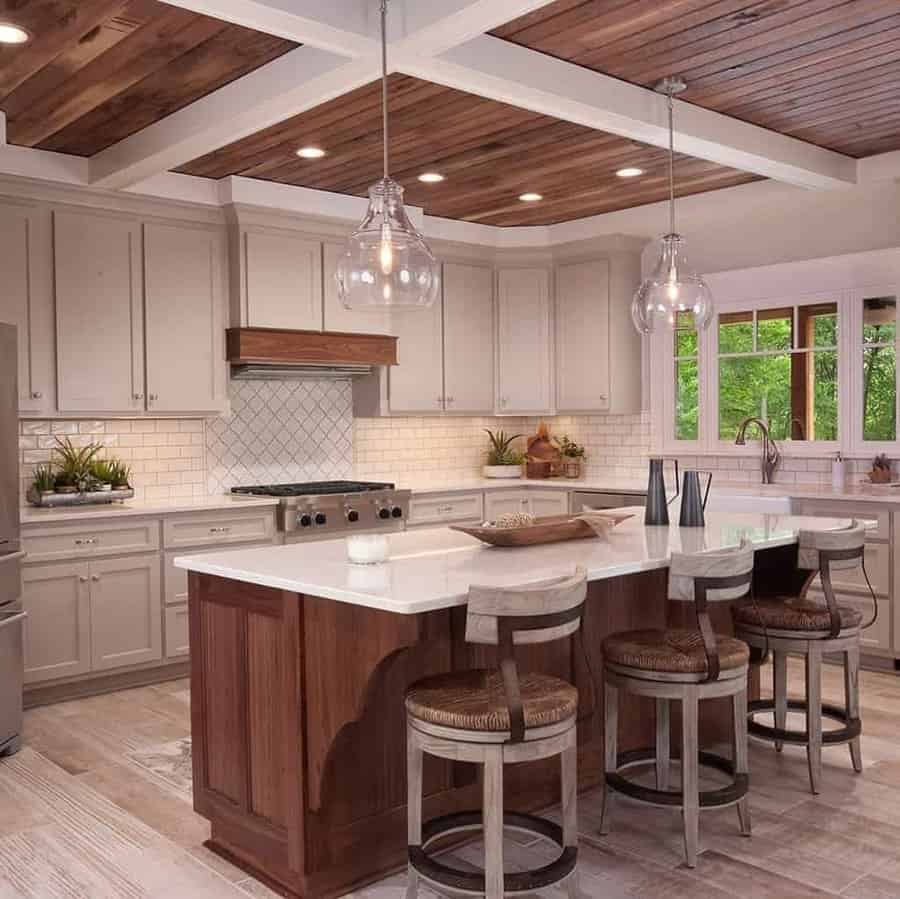 Cozy kitchen with clear glass pendants and wood ceiling beams