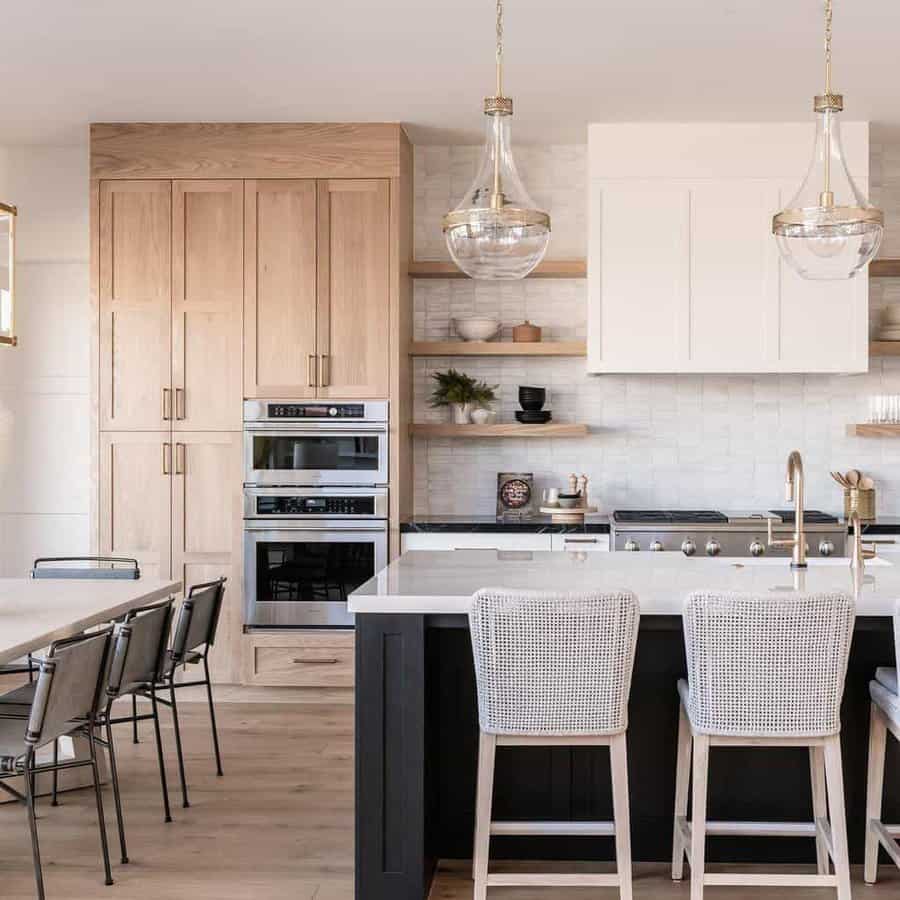 Warm kitchen with glass pendants and a wooden island