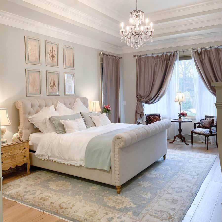 Elegant bedroom with tufted headboard and classic chandelier