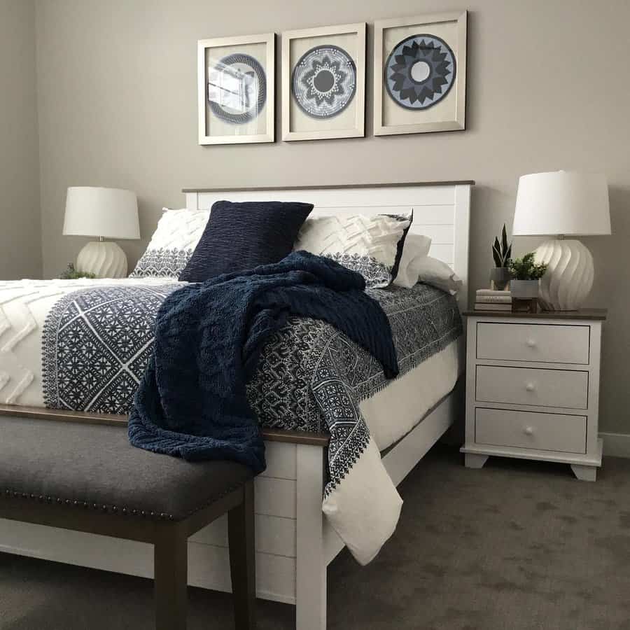 Modern bedroom with patterned blue bedding and framed art