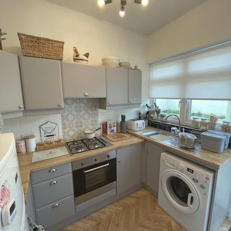 Small cozy kitchen with grey cabinets and wooden countertops