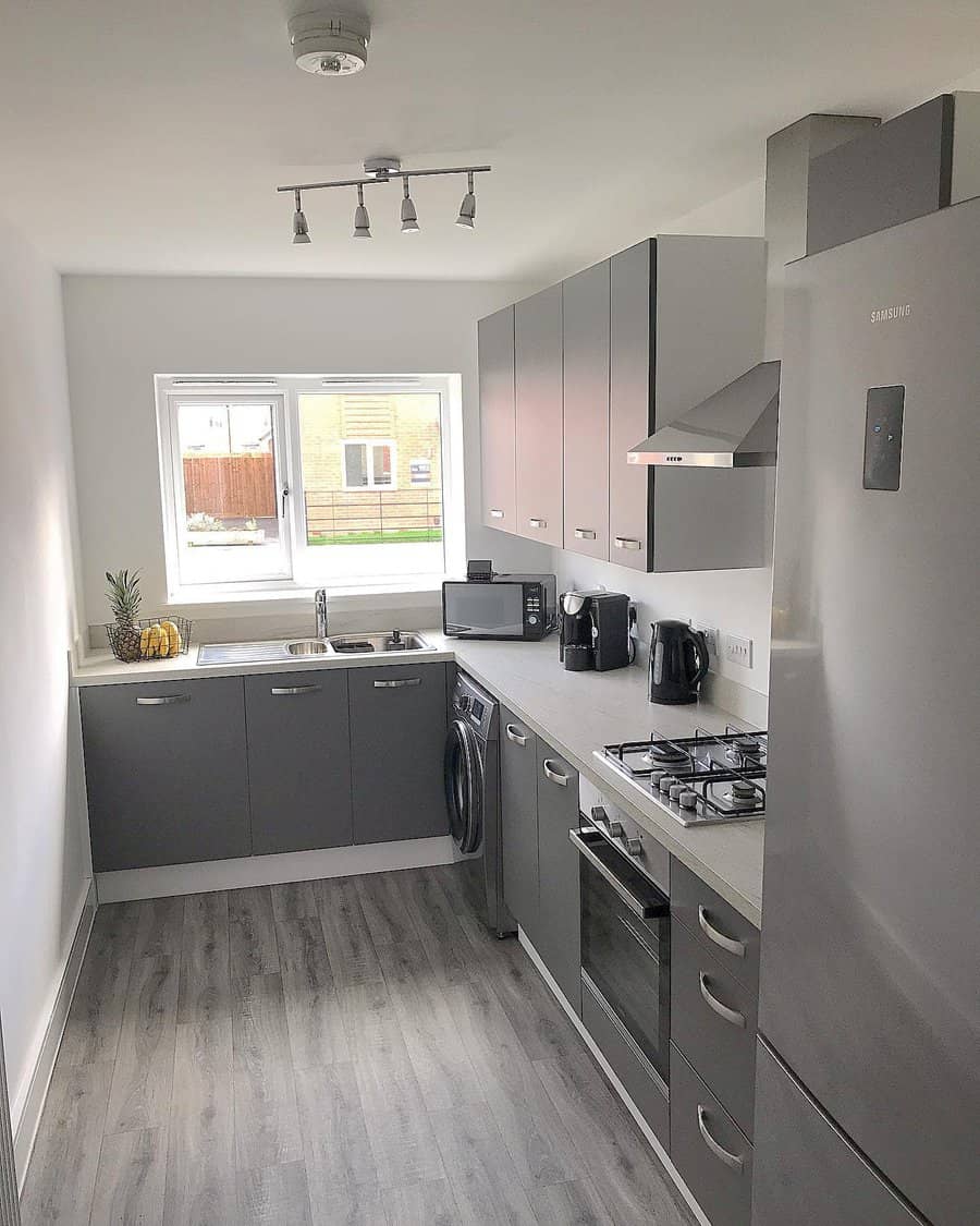 Modern grey kitchen with natural light and track lighting