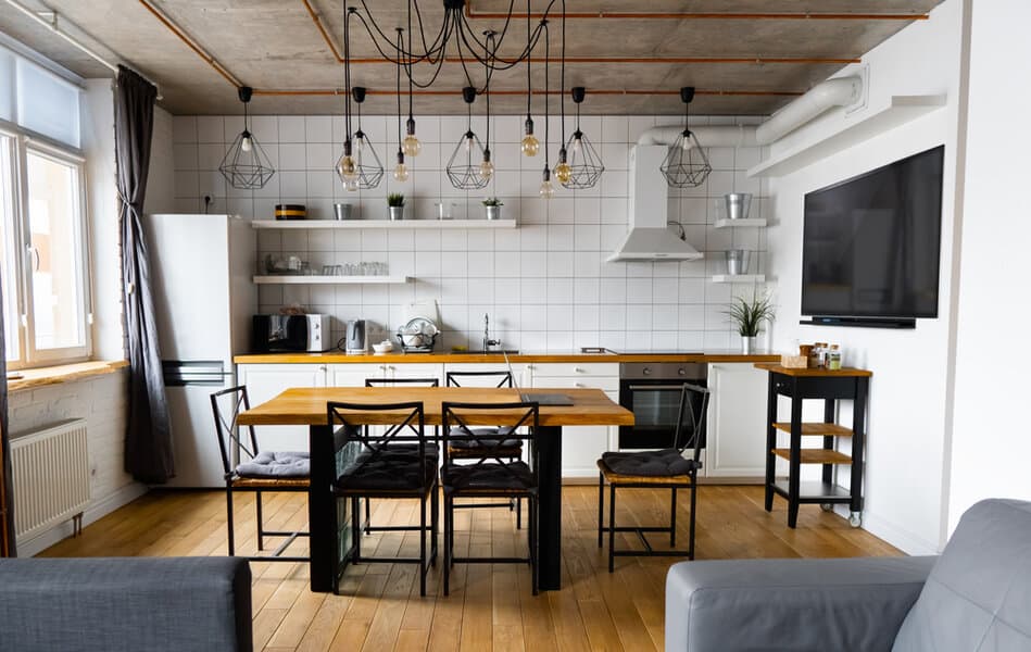 Urban loft kitchen with exposed beams and eclectic pendant lights