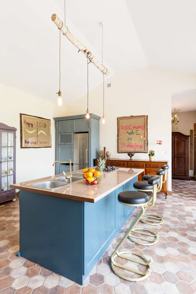 Artistic kitchen with whimsical pendant lights and hex tile floor