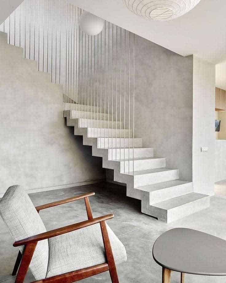 Contemporary living room with a staircase and a metal railing