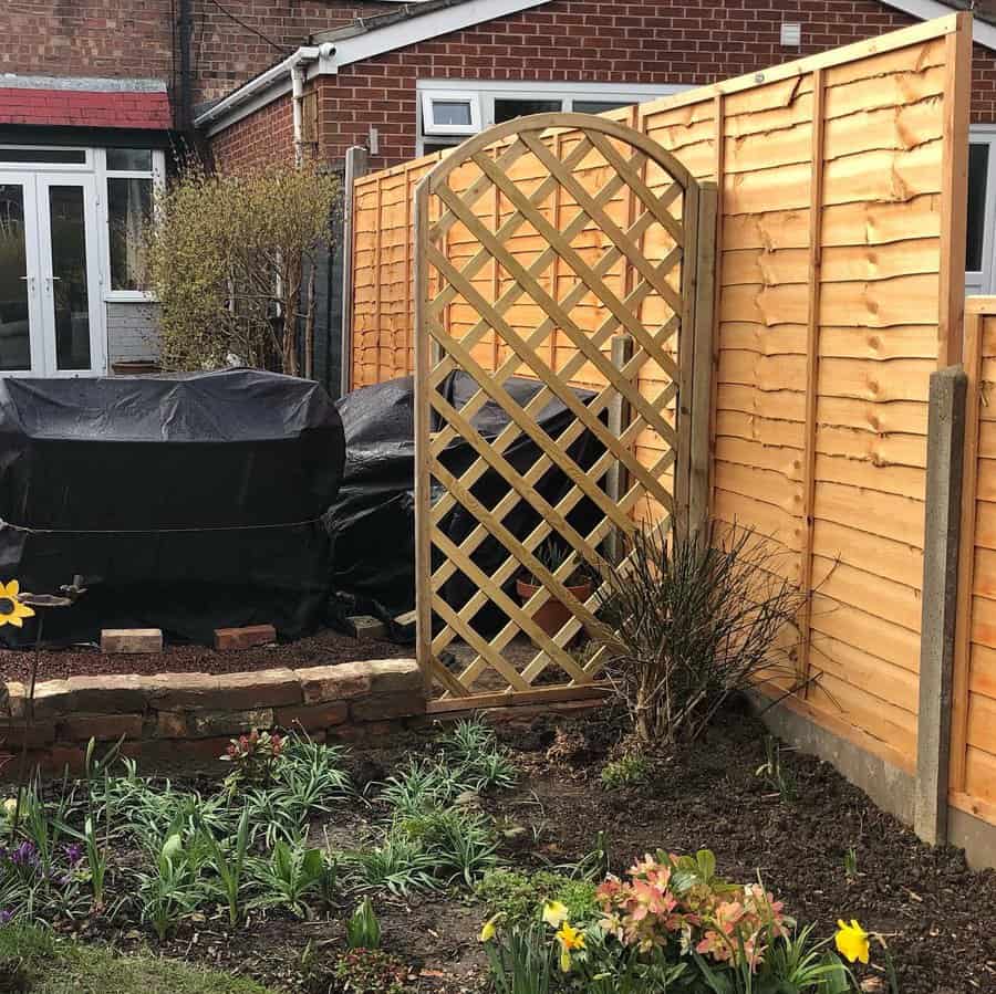 Garden corner with diamond lattice trellis and spring blooms