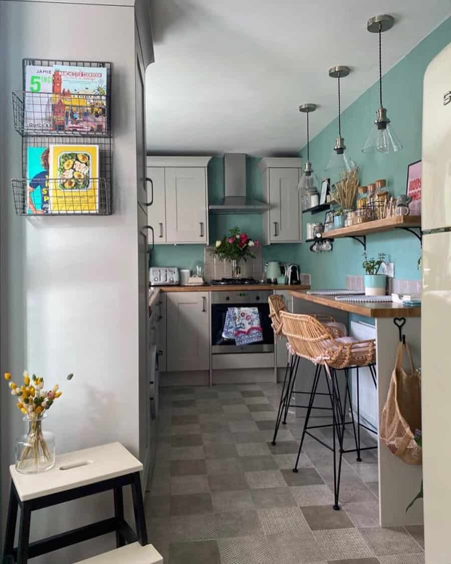 Chic kitchen with mint cabinets and pendant lights