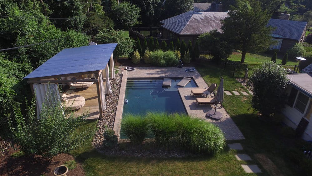 Backyard pool with covered seating area