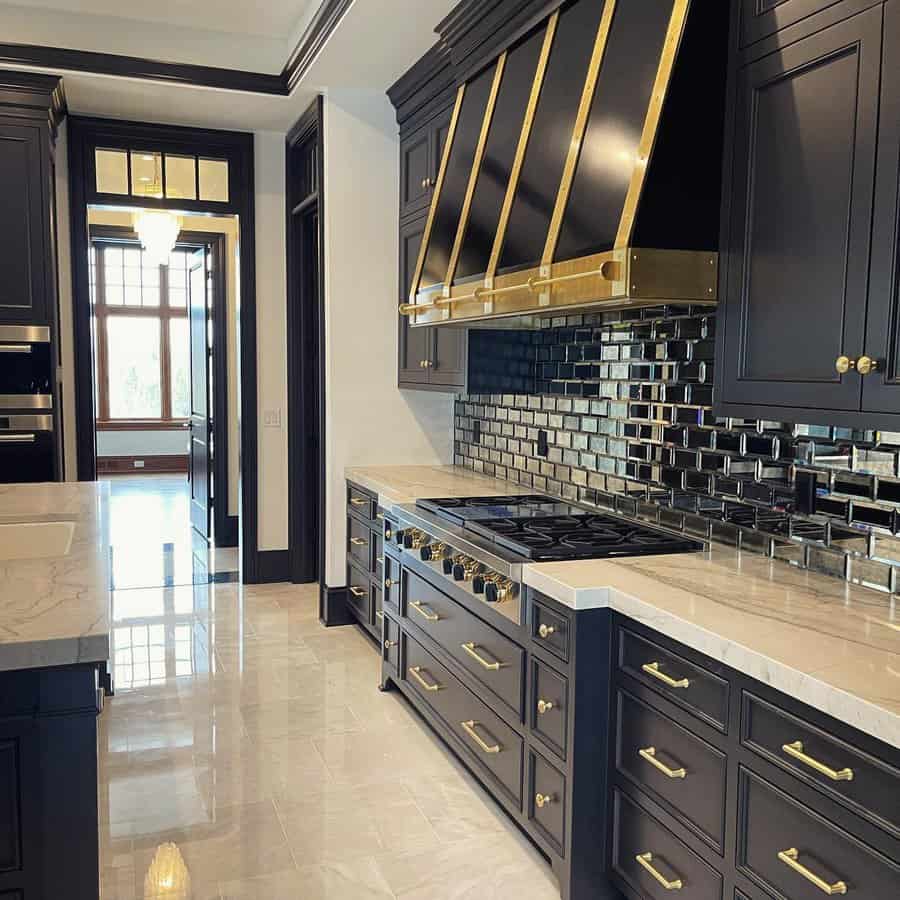 Luxurious kitchen with gold accents and dark cabinets