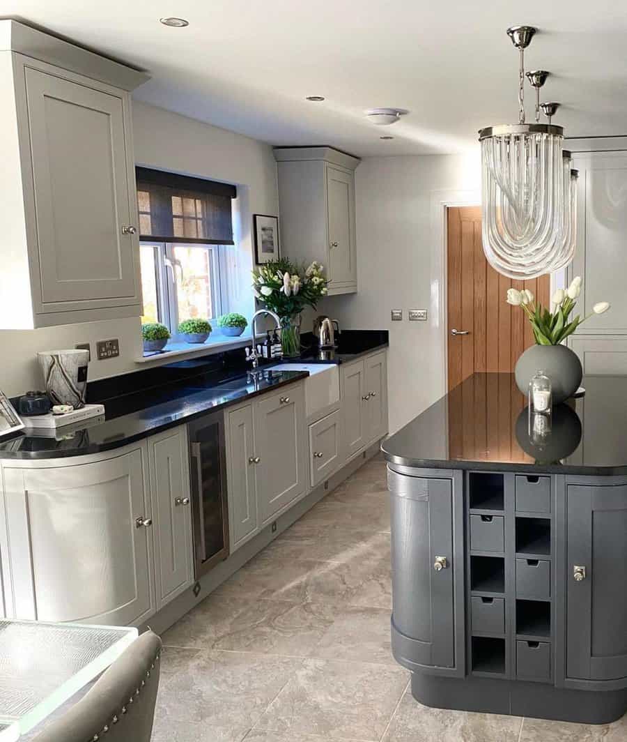 Elegant kitchen with taupe cabinets and chandelier