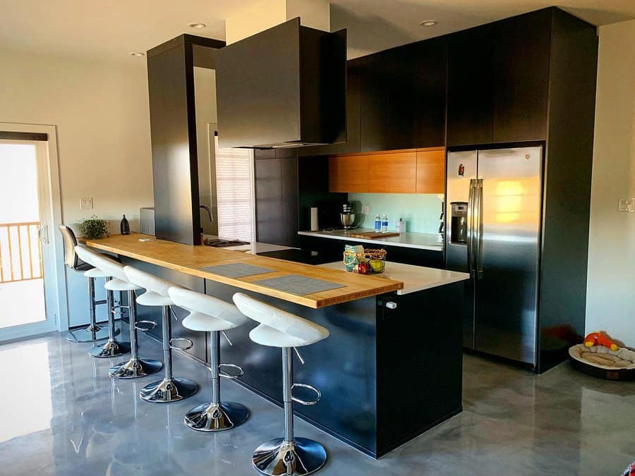 Modern kitchen with a large black island in the middle