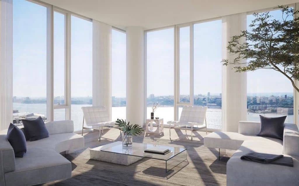 Luxurious white living room with glass walls and beach view