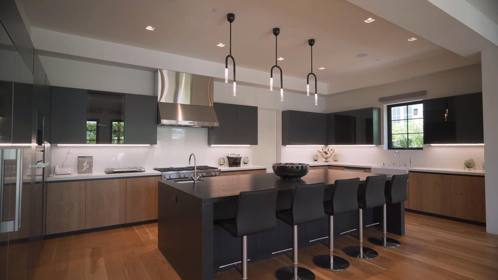 Modern kitchen with chic pendant lights and dark accents