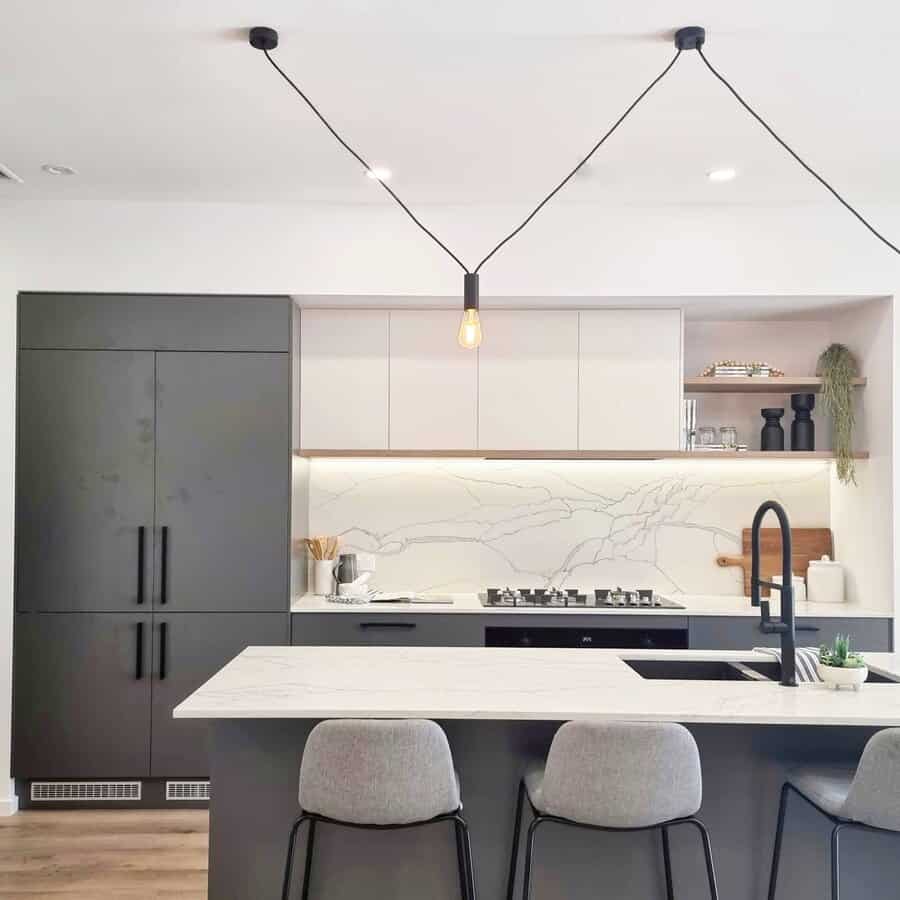 Minimalist kitchen with sleek pendant lighting and marble backsplash