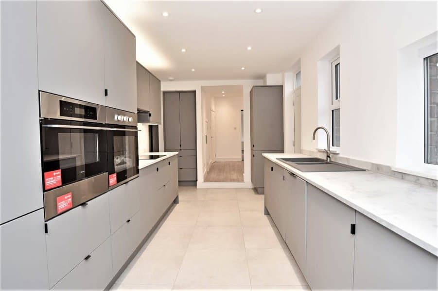 Minimalist kitchen design with grey cabinets and marble countertop