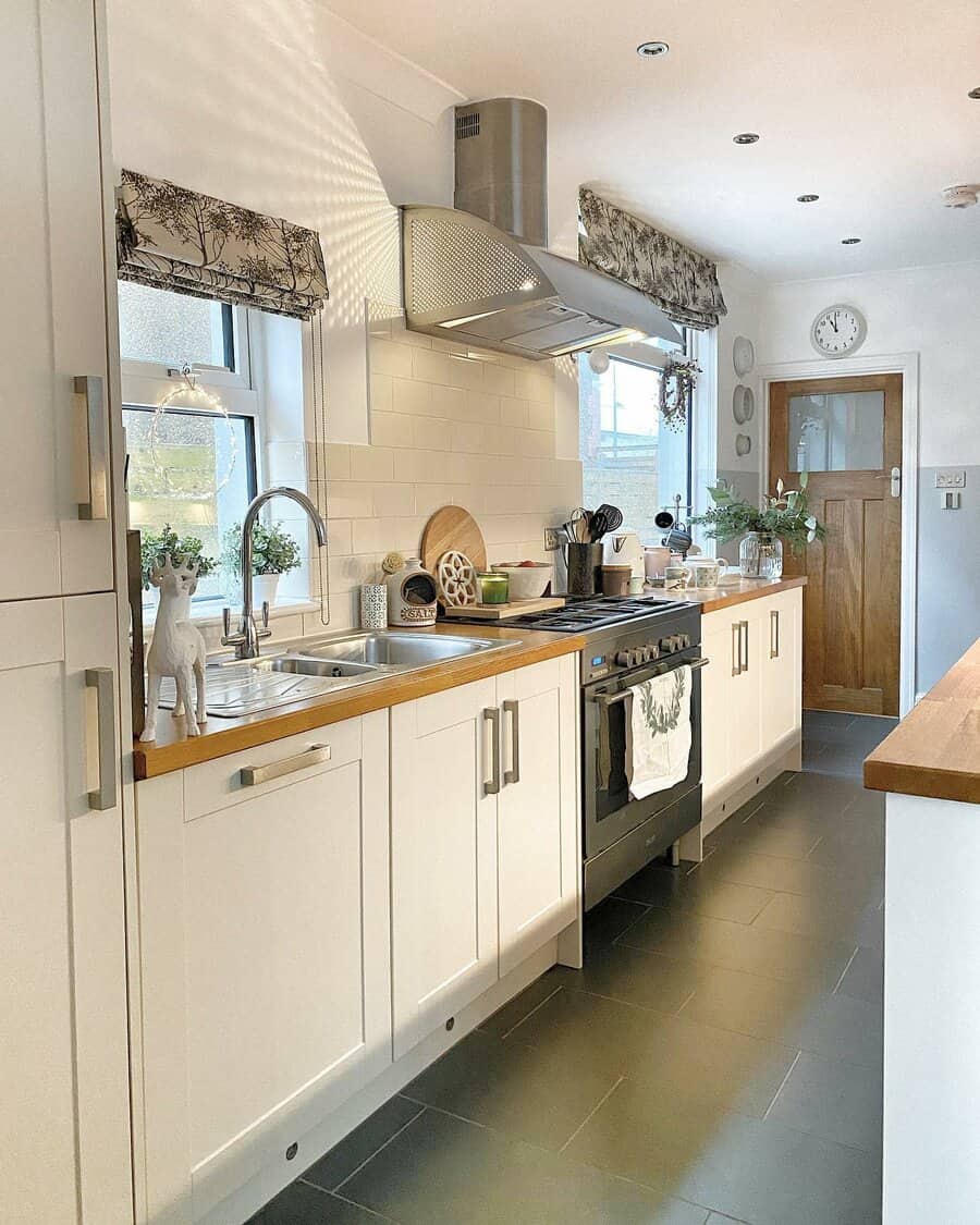 Kitchen with white cabinets and a black tile floor