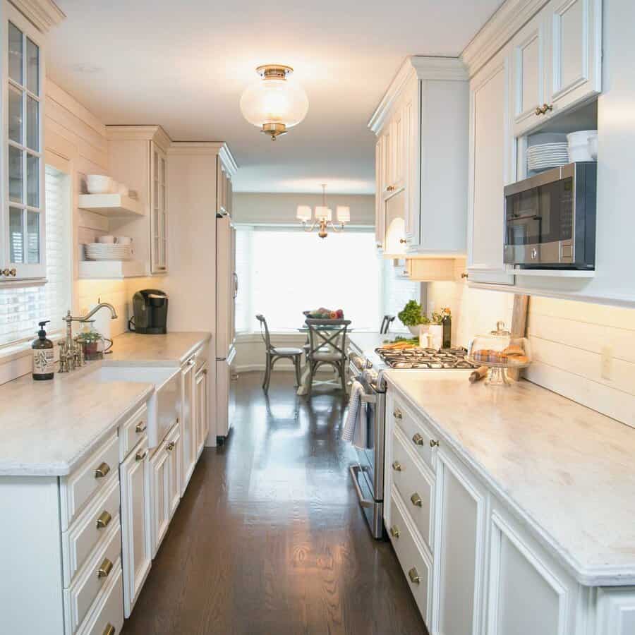 Bright kitchen with white cabinets and a hardwood floor