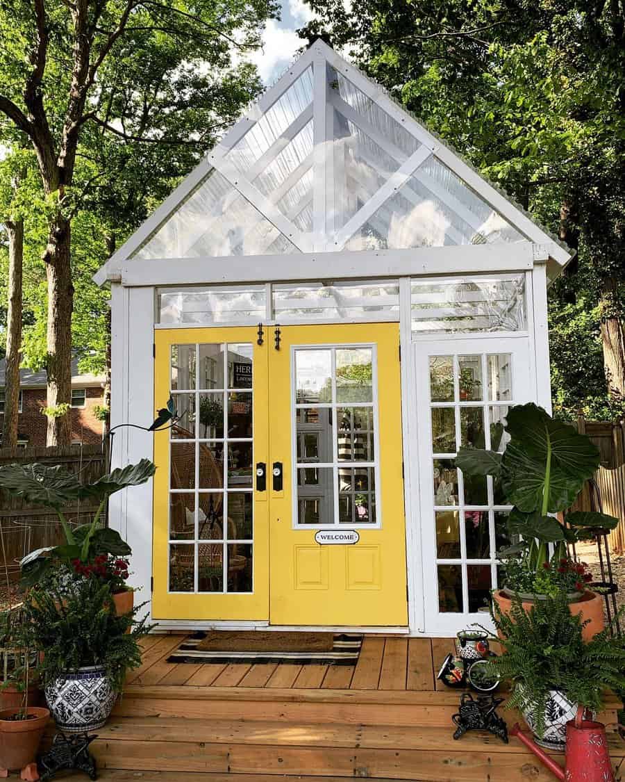 White greenhouse with a yellow door 