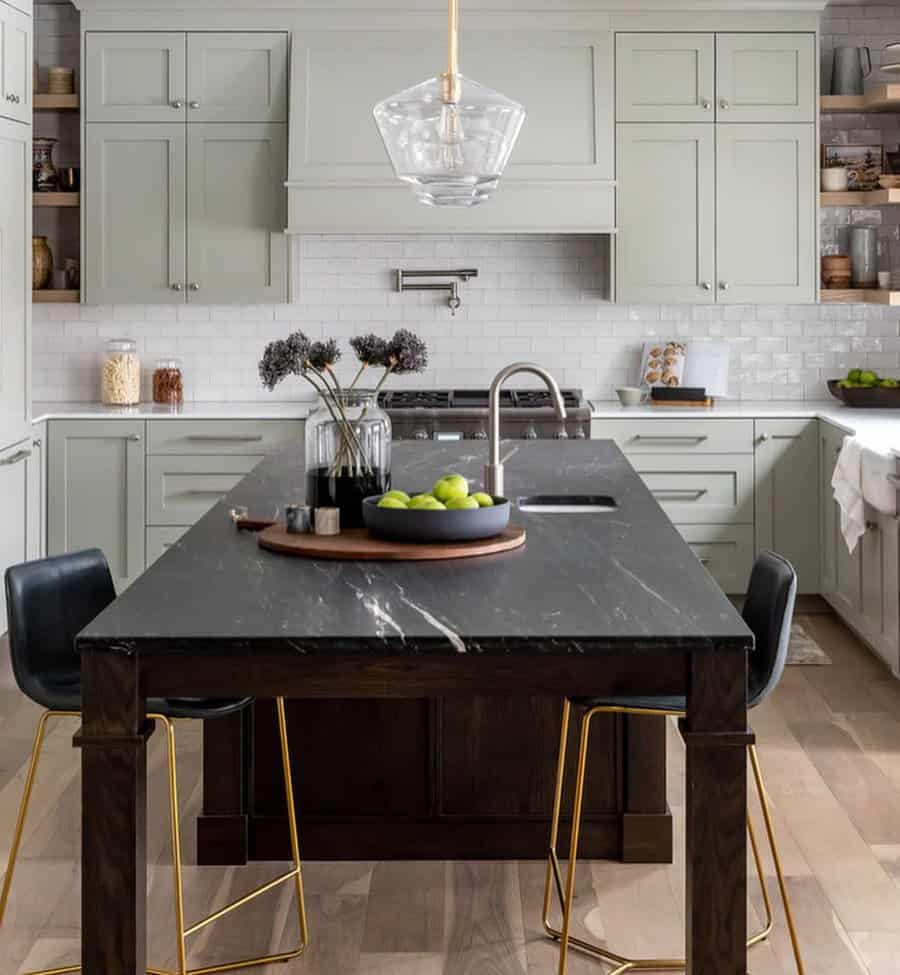 Sophisticated kitchen with black marble island and chic pendant light