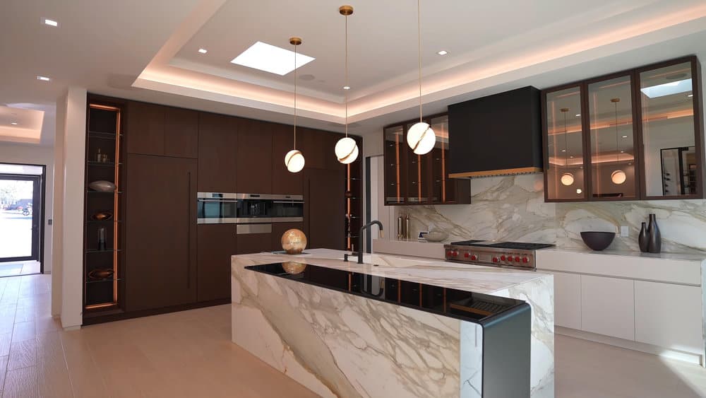 Sophisticated kitchen with marble features and orb pendants