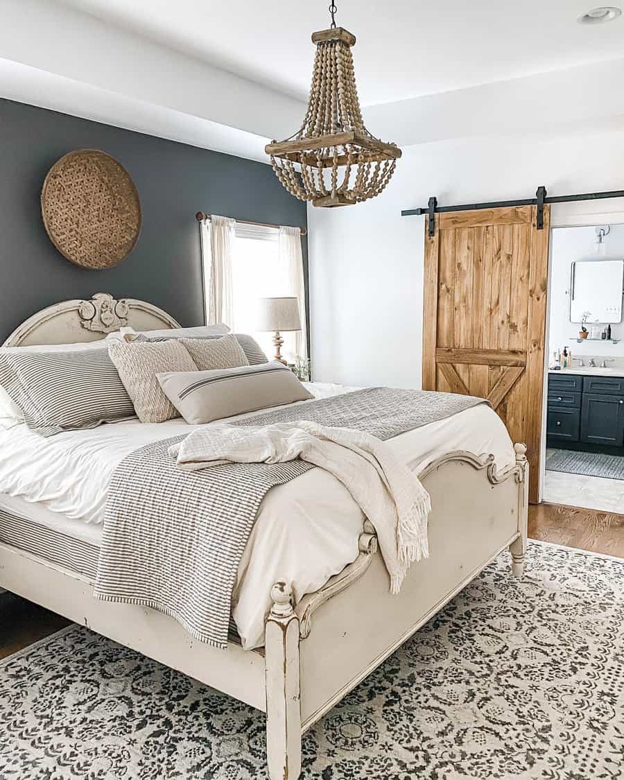 Farmhouse bedroom with beaded chandelier and barn door